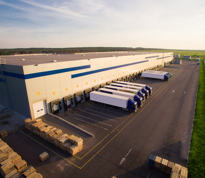 Warehouse building with delivery trucks parked in the loading area