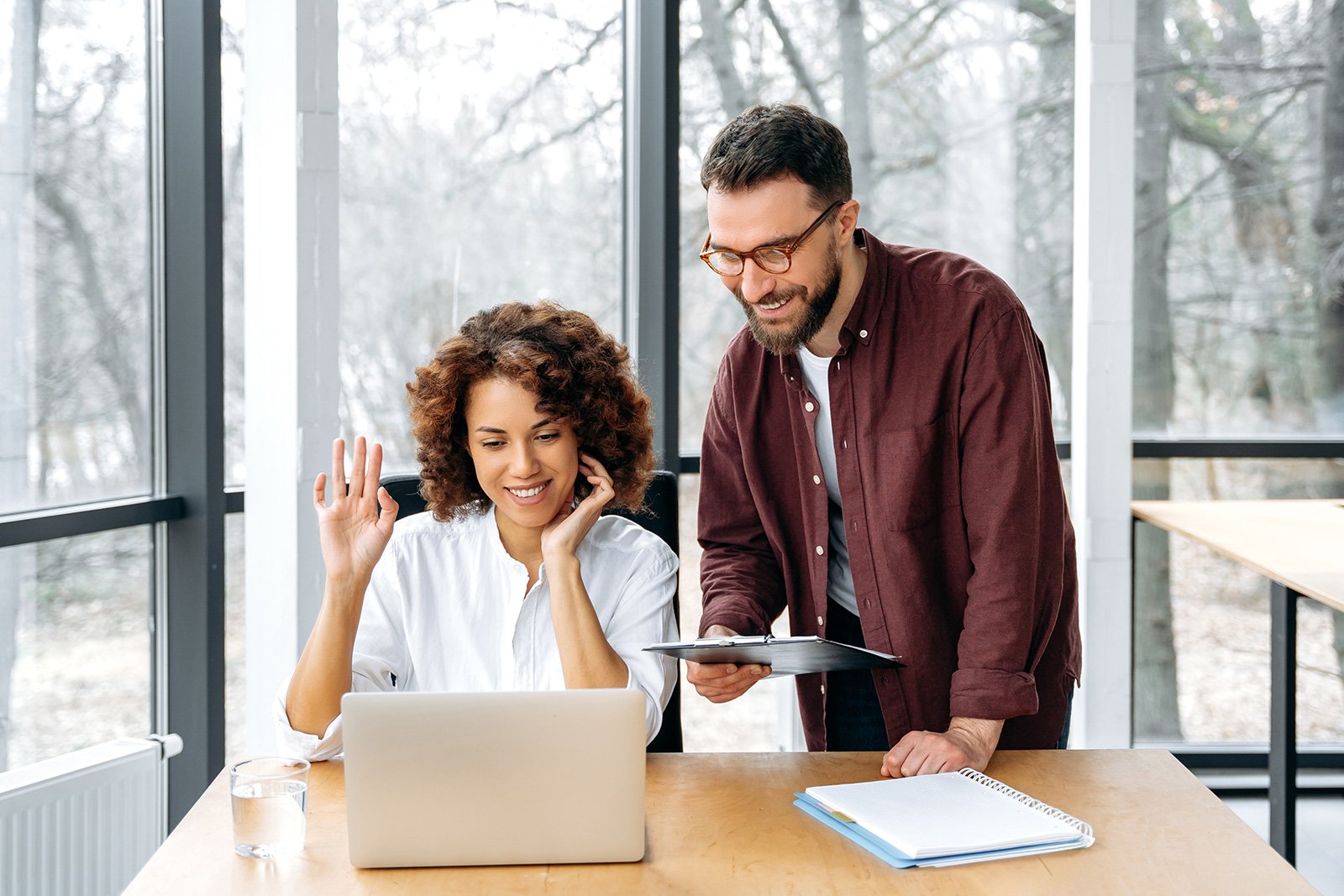 man and woman looking at computer